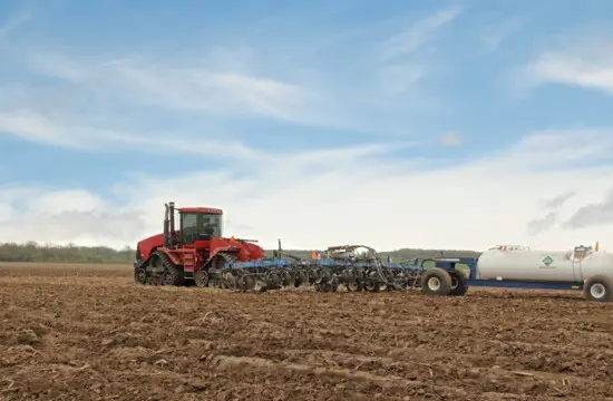 Planter applying anhydrous ammonia fertilizer to a field